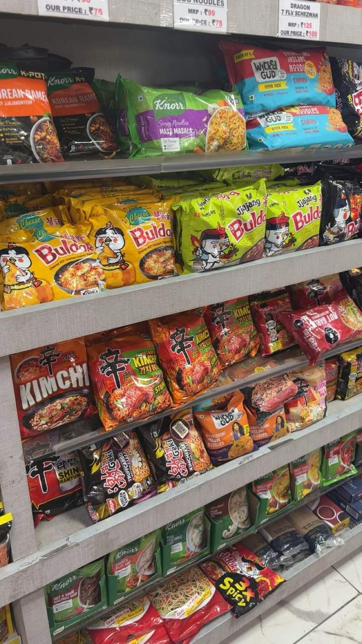 Instant noodle cups stacked on a shelf