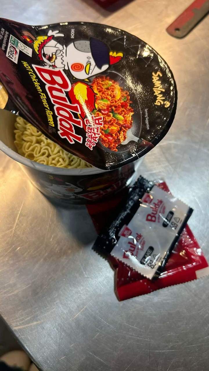 An open Buldak ramen cup with seasoning