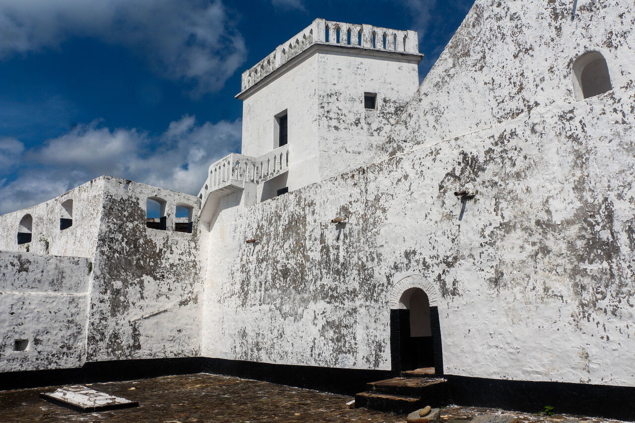 Fort St. Anthony — whitewashed courtyard and tower, Axim